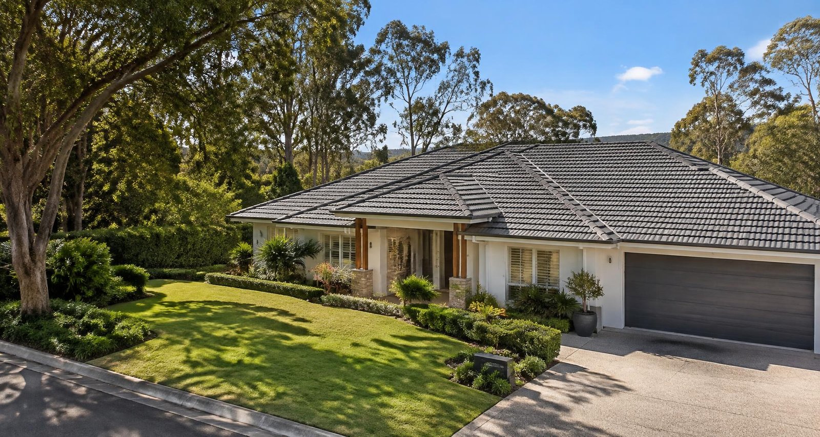 A restored graphite tiled roof on a bright suburban home